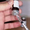 Hand drawing testosterone injection from vial showing how long TRT takes to work for men in Oswego IL