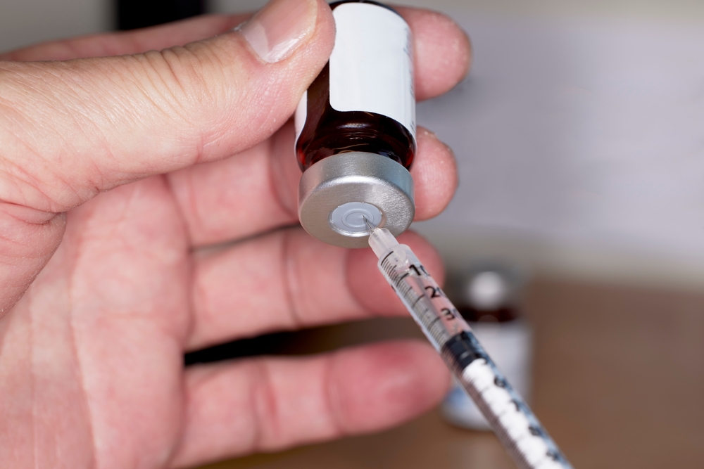 Hand drawing testosterone injection from vial showing how long TRT takes to work for men in Oswego IL