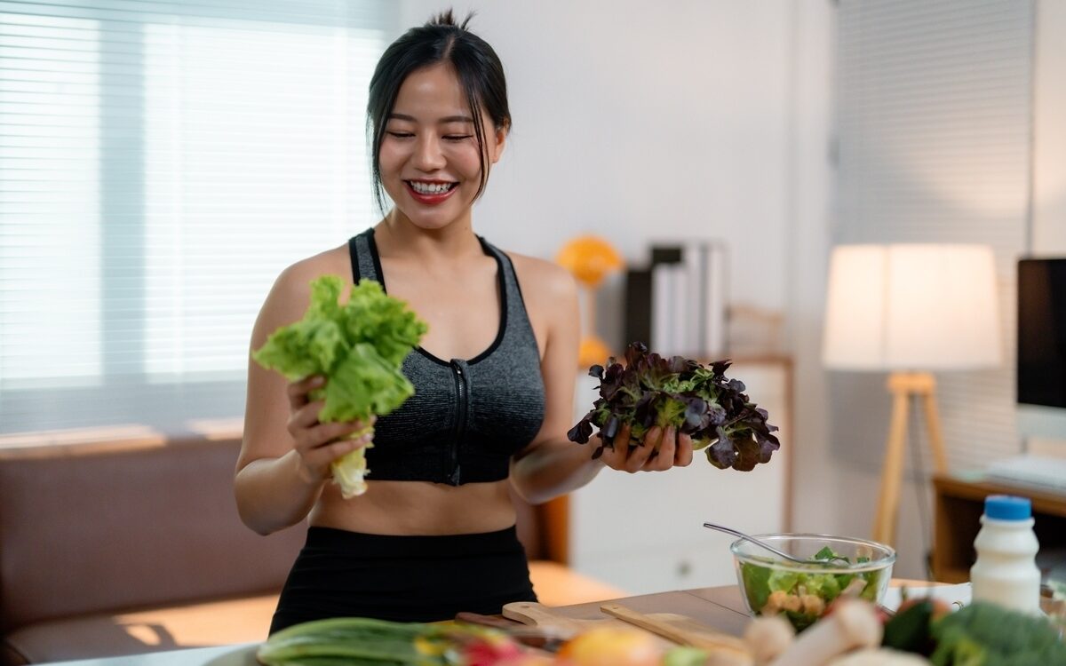 Woman eating healthy vegetables wondering why hormonal imbalance weight gain happens despite a good diet