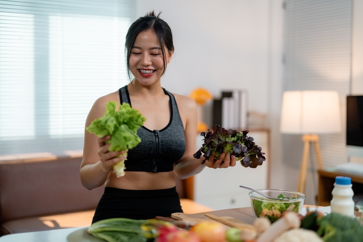 Woman eating healthy vegetables wondering why hormonal imbalance weight gain happens despite a good diet