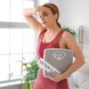 Woman in her 40s learning about perimenopause vs menopause symptoms at home
