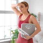 Woman in her 40s learning about perimenopause vs menopause symptoms at home