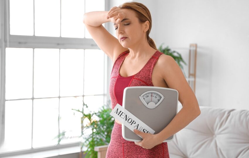 Woman in her 40s learning about perimenopause vs menopause symptoms at home