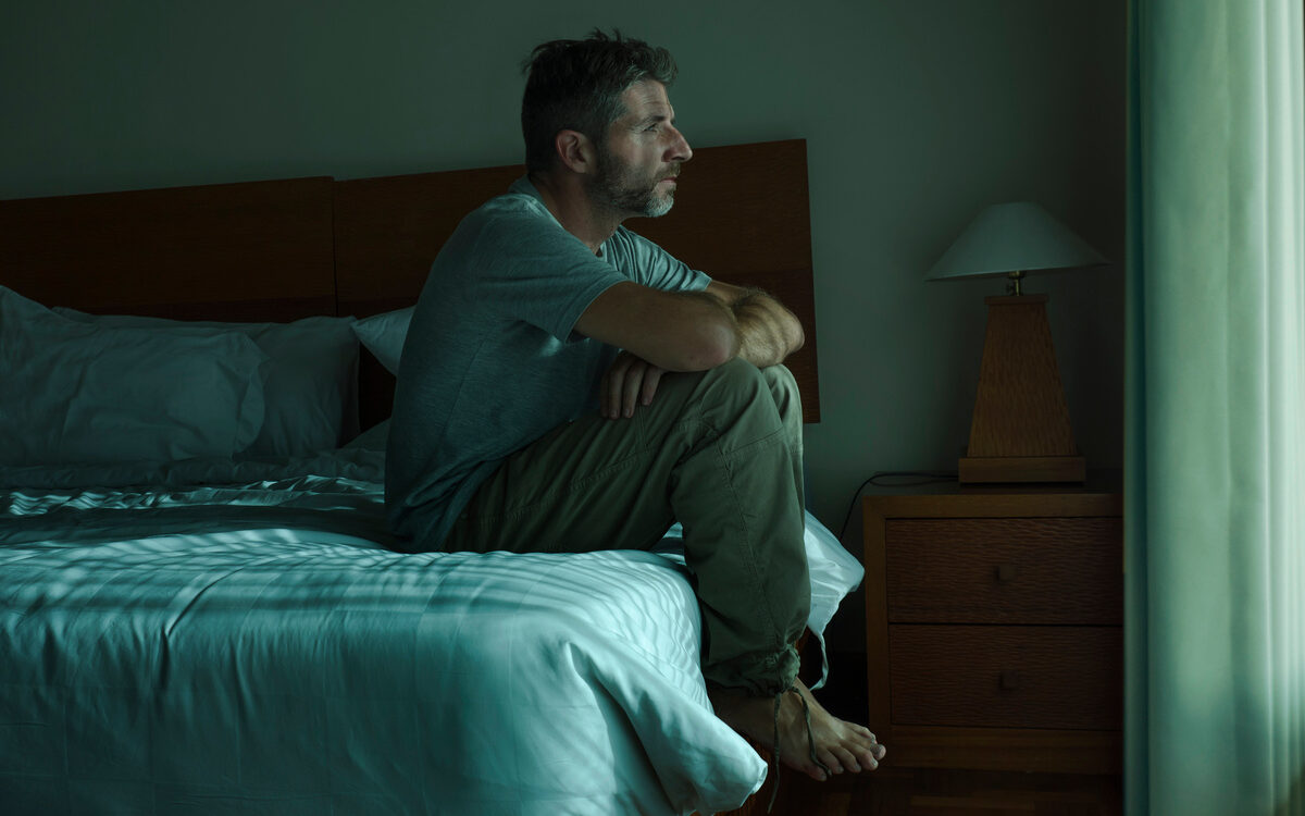 Man experiencing symptoms of low testosterone in men including persistent fatigue and low energy
