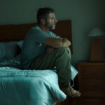 Man experiencing symptoms of low testosterone in men including persistent fatigue and low energy