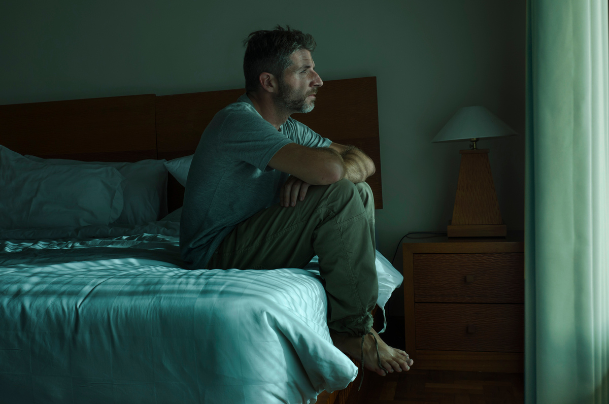 Man experiencing symptoms of low testosterone in men including persistent fatigue and low energy