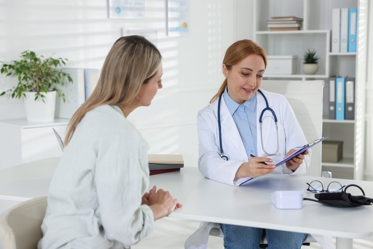 Female provider explaining how long does HRT take to work to a patient in a clinic