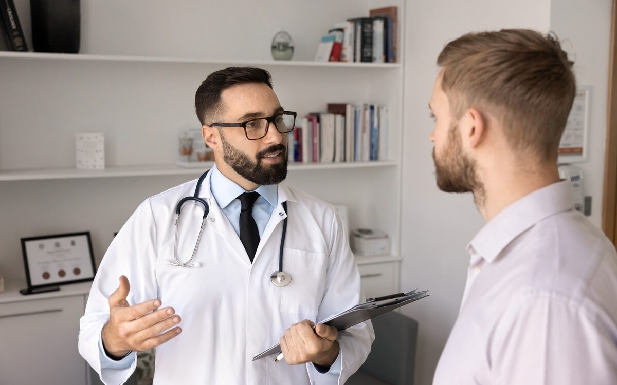 Male provider discussing low testosterone and weight gain with a patient in a clinic