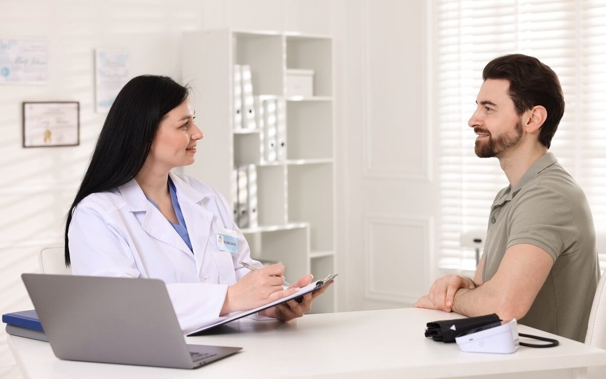 Female provider documenting TRT monitoring for men during a clinical follow-up consultation