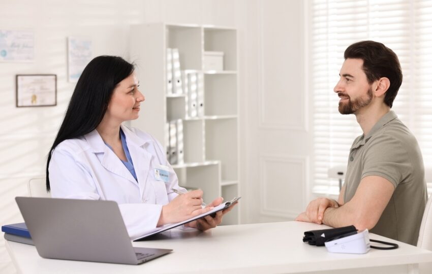 Female provider documenting TRT monitoring for men during a clinical follow-up consultation