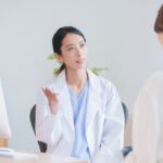 Female healthcare provider explaining bioidentical vs synthetic HRT options to a patient during a clinical consultation