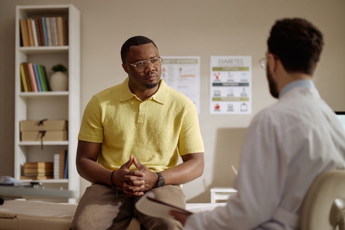 Male patient discussing forms of TRT for men with a healthcare provider during a clinical consultation