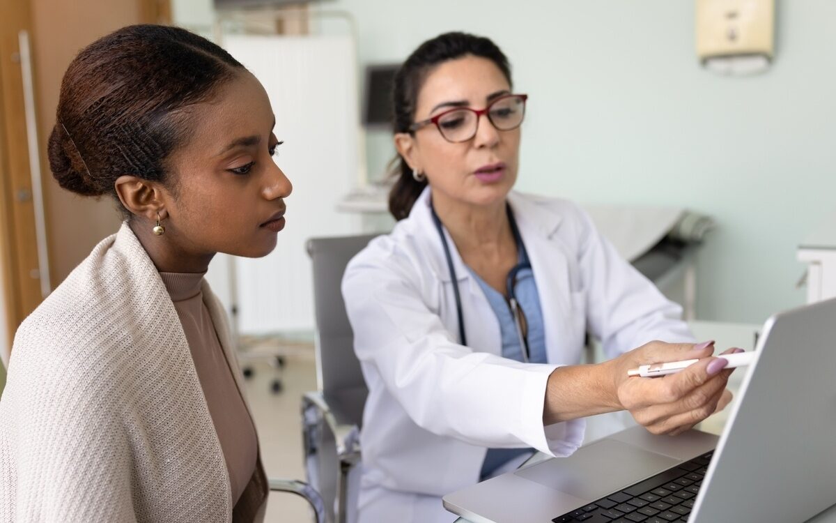 Healthcare provider reviewing keeping weight off after GLP-1 progress with a patient on a laptop
