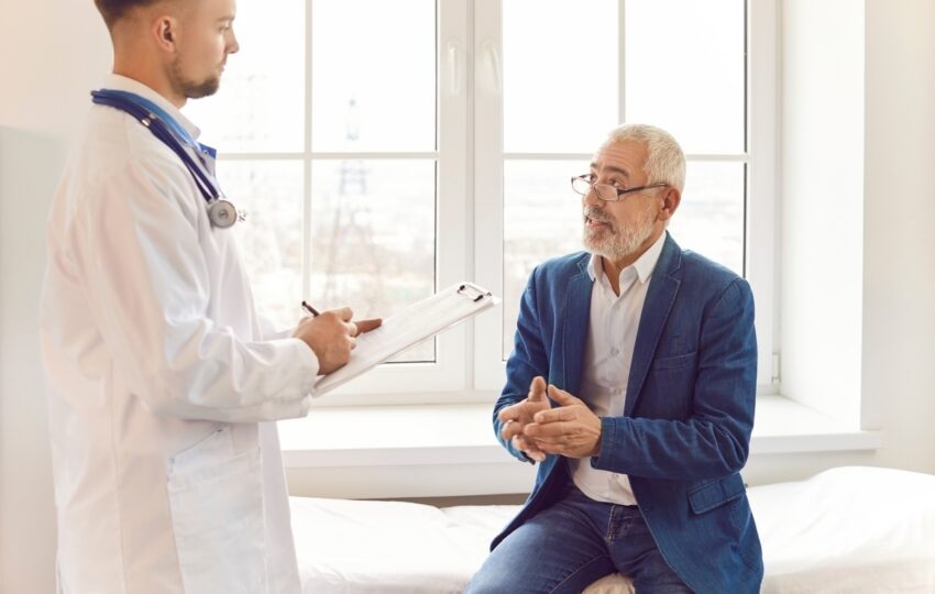 Male patient describing symptoms of fatigue to a healthcare provider during a clinical consultation about testosterone therapy and fatigue related to low energy