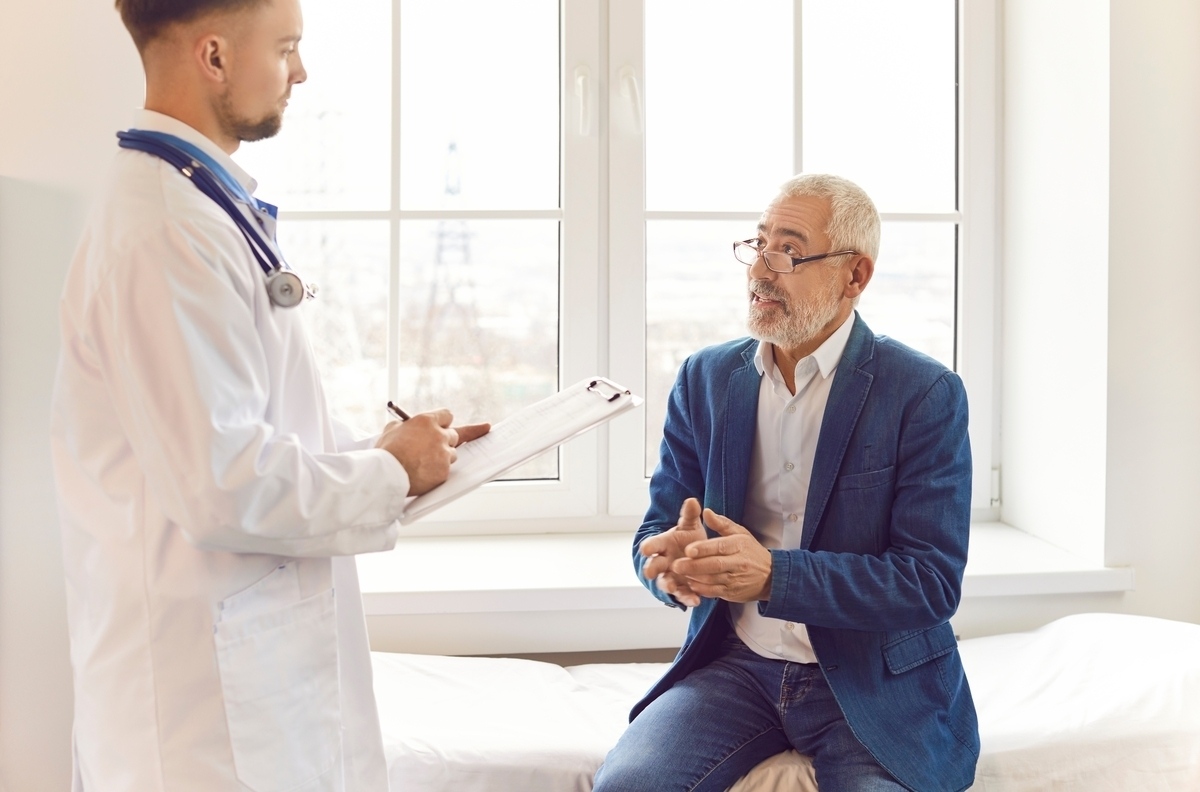 Male patient describing symptoms of fatigue to a healthcare provider during a clinical consultation about testosterone therapy and fatigue related to low energy