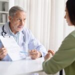 Healthcare provider explaining insurance coverage for weight loss treatment to a patient while reviewing documentation during a clinical consultation